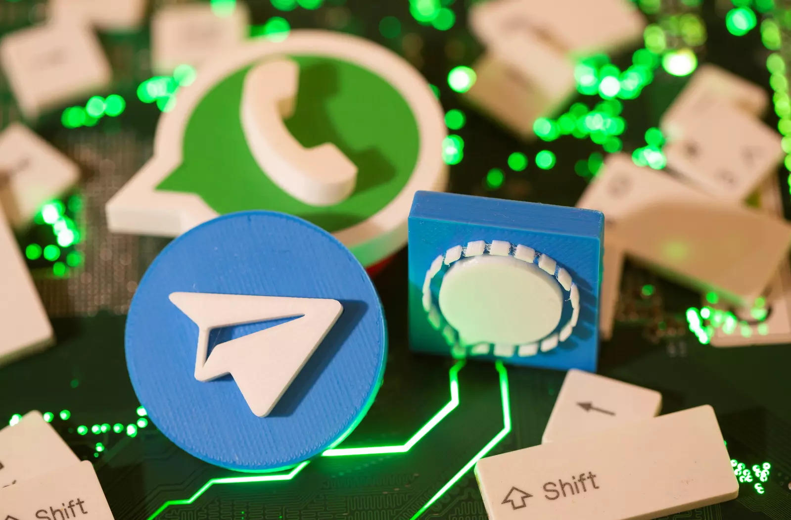 Illustration of 3D printed Facebook, Signal and WhatsApp logos and keyboard buttons on a computer motherboard